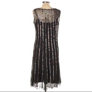 Sandra Darren cocktail dress.Back peek a boo opening.Sheer cover over black slip